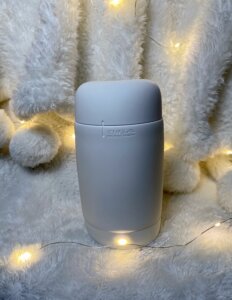 Tenga Puffy Sugar White standing up, both caps on. 