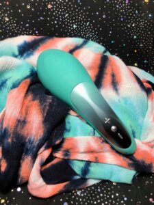 Hot Octopuss Pulse Queen face down on a tye dye fabric, the crown logo can be seen