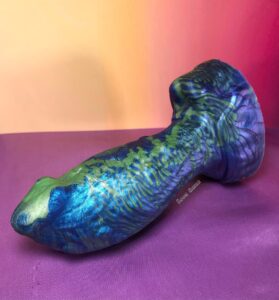Fugu plug from Uberrime in medium. A silicone vaginal or butt plug in an array of blue, purple, and greens.