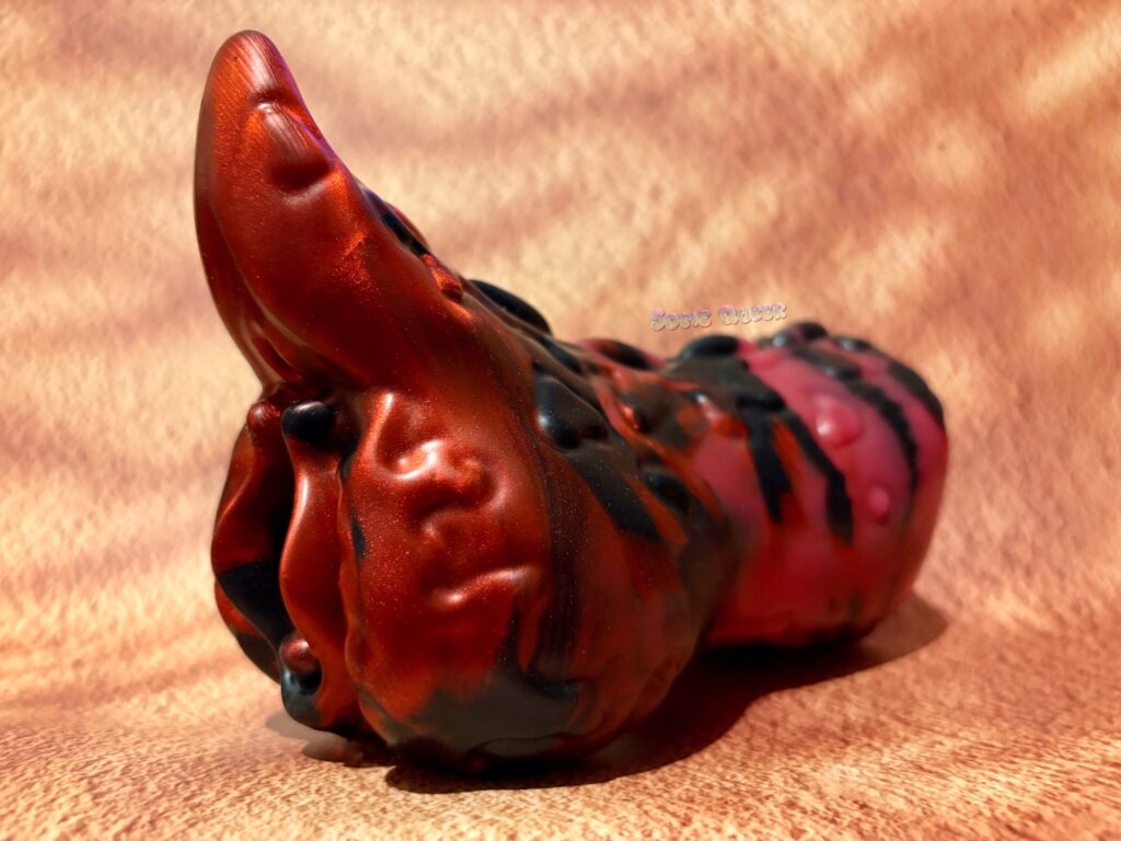 Petra the Kobold stroker from Wandering Bard Toys, in the Krampus coloration: matte red, sparkly red, and sparkly black