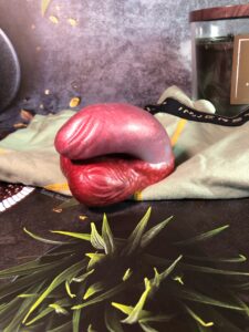 Mr. Peacock Packer in merlot, laying on a pair of sage green boxer-briefs. 
