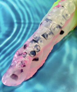 Levaina tentacle dildo posed diagonally on a blue water background