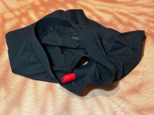 Showing both pockets on the SnugHer boxer harness with a red bat go bullet vibe in the top pocket, while the second pocket is lifted up to show the inside. 