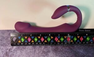 Eggplant Vibrator with a ruler in front of it to show measurement