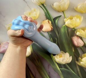 The Crassie Grinding base Dildo being squeezed at the base to show how squishy the material is.